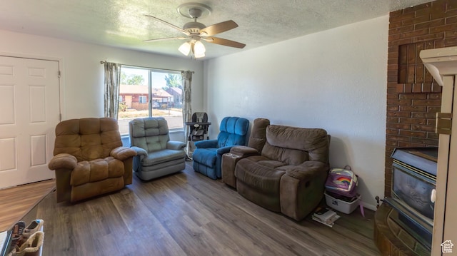 405 Bramblewood Dr, Cedar City, UT 84721 - living room with wood finished floors, ceiling fan, a textured ceiling, and a wood stove