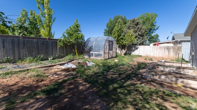 405 Bramblewood Dr, Cedar City, UT 84721 - fenced backyard with a vegetable garden, an exterior structure, and an outbuilding