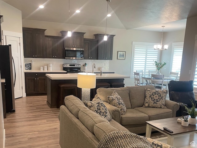 4422 W 2425 N, Plain City, UT 84404 - living area featuring light wood-style floors, a chandelier, lofted ceiling, and recessed lighting