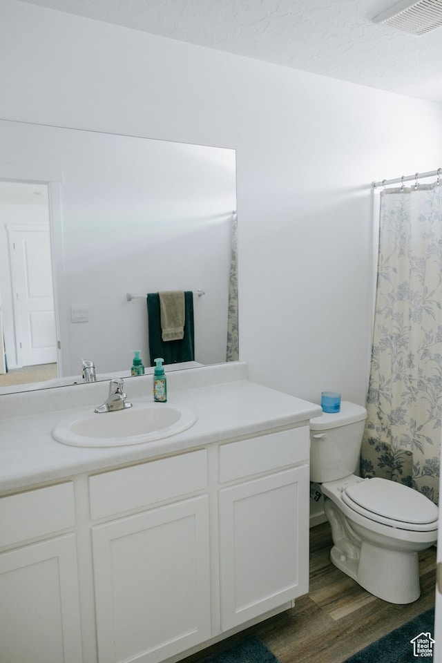 1859 N Blue Iris Ave Unit 1078, Tooele, UT 84074 - full bath featuring vanity, toilet, wood finished floors, and a shower with curtain