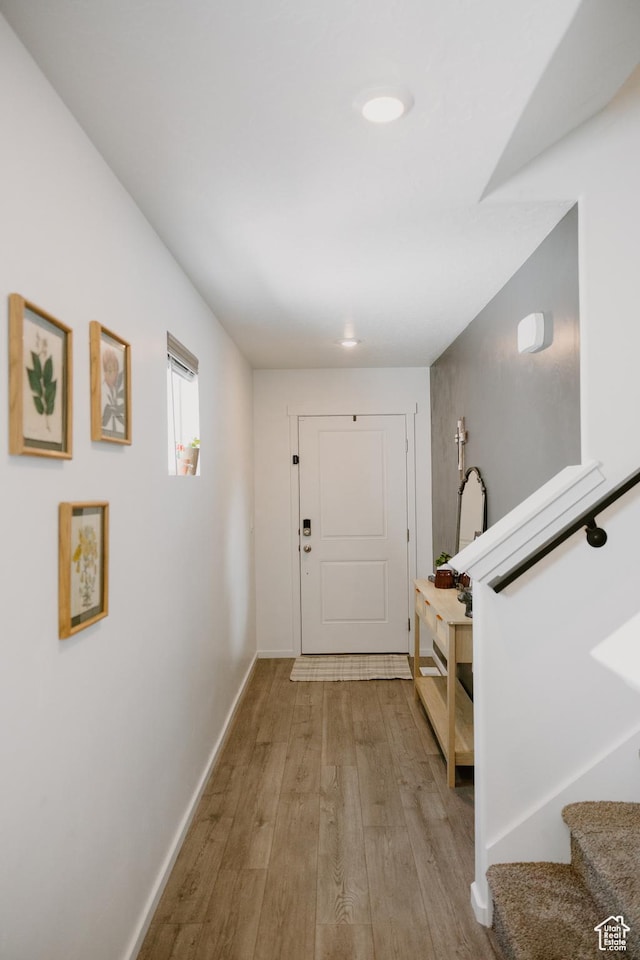 1859 N Blue Iris Ave Unit 1078, Tooele, UT 84074 - foyer entrance with light wood-style flooring, stairs, and baseboards