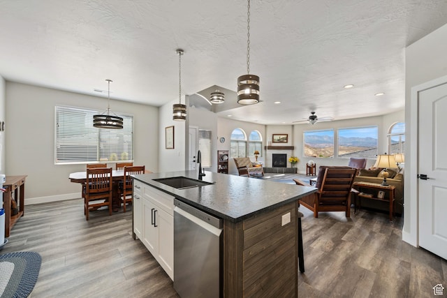 1160 N Main St, Hurricane, UT 84737 - kitchen featuring stainless steel dishwasher, a sink, dark countertops, dark wood-type flooring, and baseboards