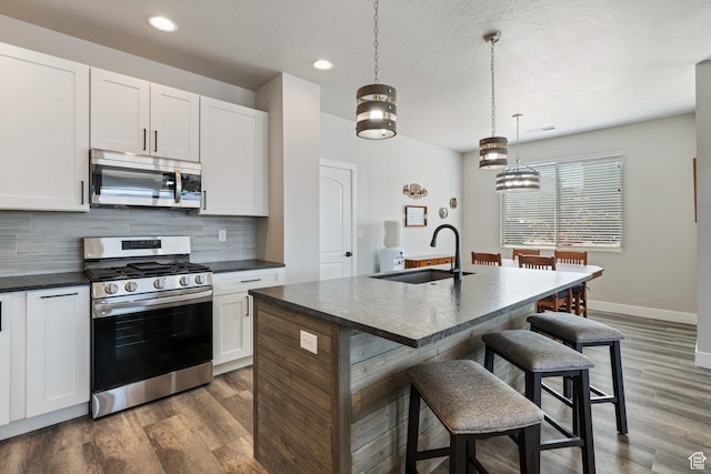 1160 N Main St, Hurricane, UT 84737 - kitchen featuring appliances with stainless steel finishes, a sink, dark countertops, backsplash, and recessed lighting