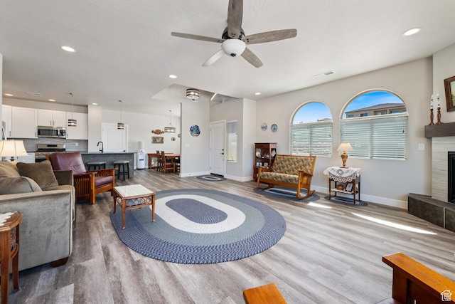 1160 N Main St, Hurricane, UT 84737 - living area featuring wood finished floors, baseboards, ceiling fan, recessed lighting, and a fireplace