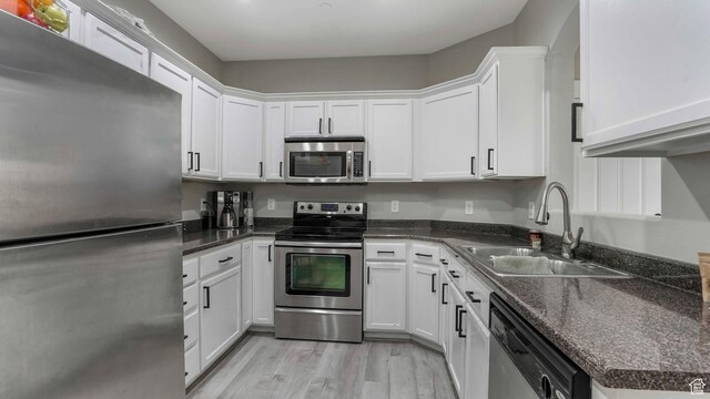 156 W Springview Dr Unit 505, Saratoga Springs, UT 84045 - kitchen with appliances with stainless steel finishes, a sink, white cabinets, and light wood finished floors