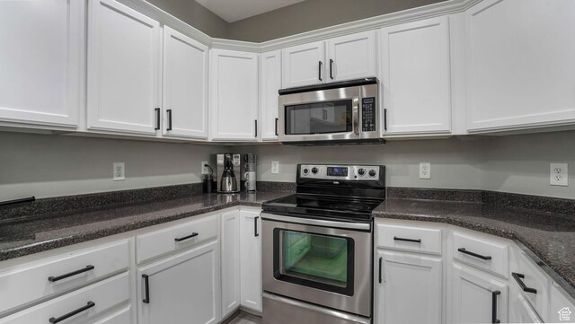 156 W Springview Dr Unit 505, Saratoga Springs, UT 84045 - kitchen with appliances with stainless steel finishes, white cabinetry, and dark stone counters