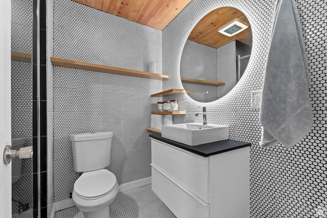 1616 E Waters Ln, Sandy, UT 84093 - bathroom with vanity, toilet, tile walls, wooden ceiling, and tile patterned floors