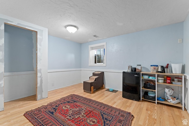 1616 E Waters Ln, Sandy, UT 84093 - sitting room with wood finished floors, wainscoting, and a textured ceiling