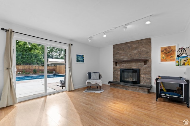 1616 E Waters Ln, Sandy, UT 84093 - living area featuring track lighting, light wood finished floors, and a fireplace