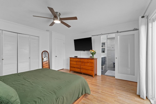 1616 E Waters Ln, Sandy, UT 84093 - bedroom featuring ornamental molding, light wood-type flooring, ensuite bath, a ceiling fan, and a barn door