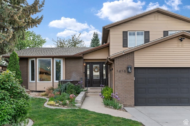 1616 E Waters Ln, Sandy, UT 84093 - split level home with brick siding, concrete driveway, a garage, and a front lawn