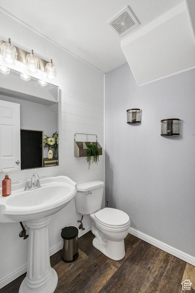 1038 N Plaza Dr, Richfield, UT 84701 - half bathroom with wood finished floors, toilet, and baseboards