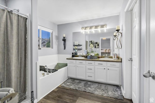 1038 N Plaza Dr, Richfield, UT 84701 - bathroom with wood finished floors, double vanity, a garden tub, and a shower with shower curtain