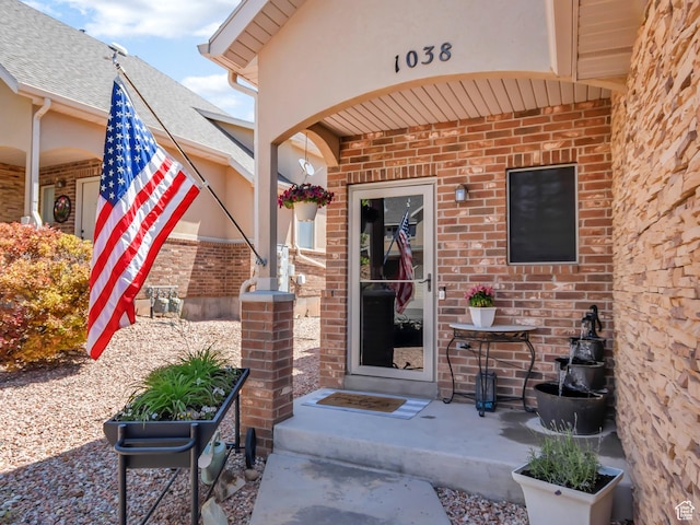 1038 N Plaza Dr, Richfield, UT 84701 - view of exterior entry with brick siding and a shingled roof