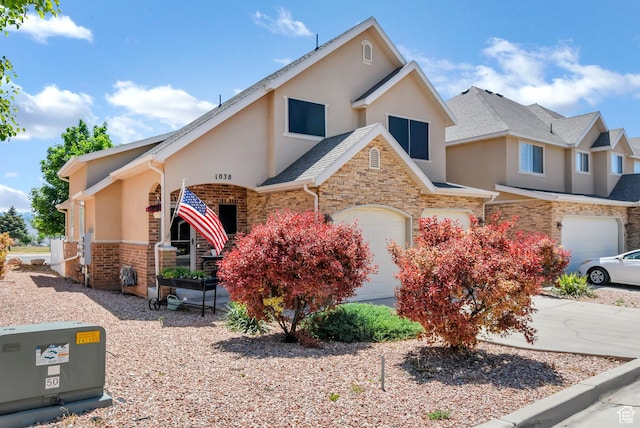 1038 N Plaza Dr, Richfield, UT 84701 - view of front of home with stucco siding, an attached garage, and stone siding