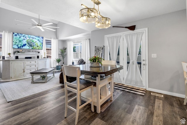 1038 N Plaza Dr, Richfield, UT 84701 - dining room featuring lofted ceiling, dark wood-style flooring, a chandelier, ceiling fan, and baseboards