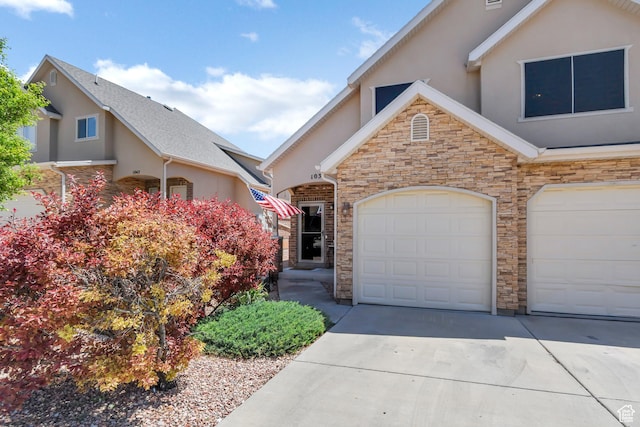 1038 N Plaza Dr, Richfield, UT 84701 - view of front of home with stucco siding, concrete driveway, and stone siding