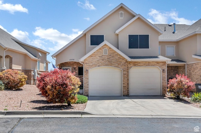 1038 N Plaza Dr, Richfield, UT 84701 - view of front of home featuring stucco siding, a garage, concrete driveway, and stone siding