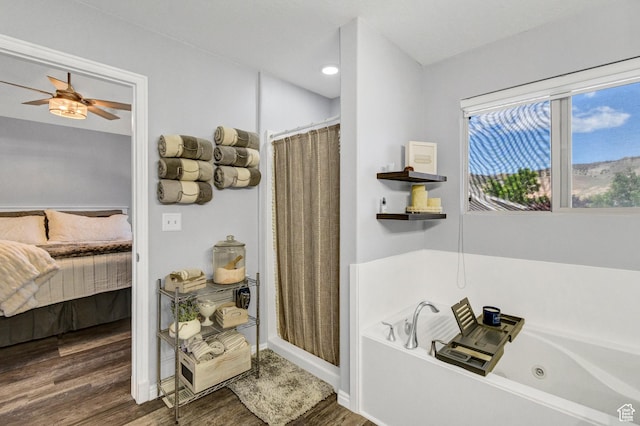 1038 N Plaza Dr, Richfield, UT 84701 - ensuite bathroom with wood finished floors, a whirlpool tub, ceiling fan, a shower with curtain, and baseboards