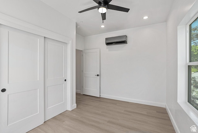 321 E 2100 S Unit 4, Salt Lake City, UT 84115 - unfurnished bedroom featuring a wall unit AC, baseboards, light wood-style floors, recessed lighting, and a closet
