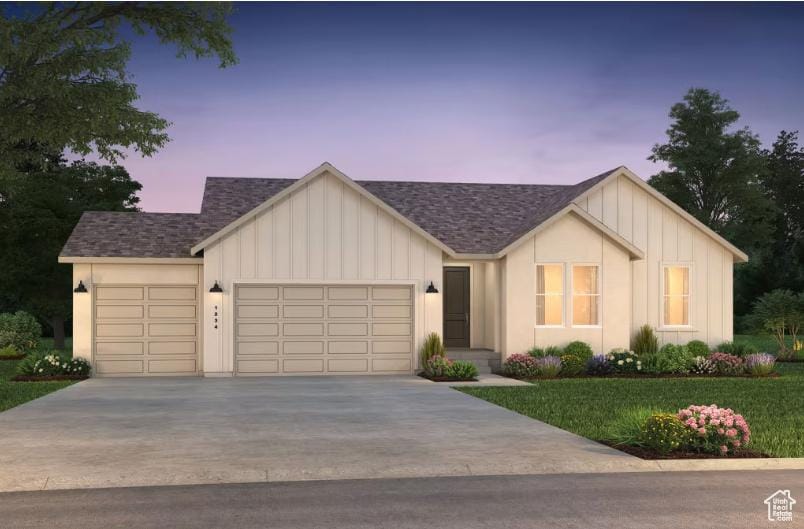 4916 N Topaz Dr Unit 317, Eagle Mountain, UT 84005 - view of front of home with a garage, board and batten siding, driveway, a front lawn, and a shingled roof