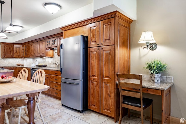 1672 Captain Molly Dr Unit 330, Park City, UT 84060 - kitchen with freestanding refrigerator, brown cabinets, backsplash, and light tile patterned floors