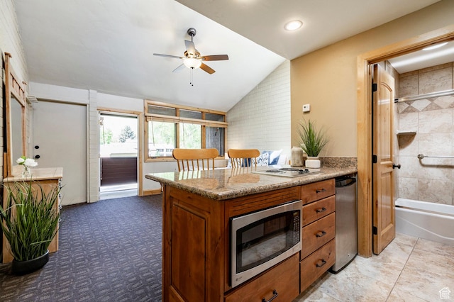 1672 Captain Molly Dr Unit 330, Park City, UT 84060 - kitchen with stainless steel microwave, brown cabinetry, vaulted ceiling, a ceiling fan, and recessed lighting
