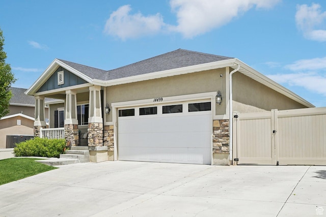 14499 S River Chase Rd, Herriman, UT 84096 - view of front facade with stone siding, a garage, driveway, a porch, and stucco siding