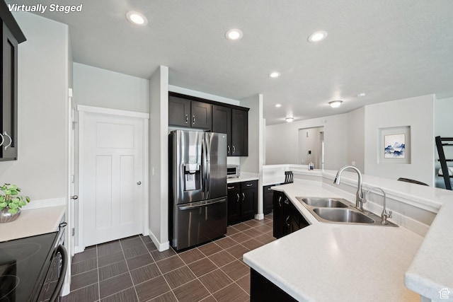 14499 S River Chase Rd, Herriman, UT 84096 - kitchen with stainless steel refrigerator with ice dispenser, a sink, light countertops, recessed lighting, and black range oven
