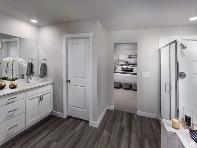 424 W 630 N Unit 0005, Tooele, UT 84074 - ensuite bathroom featuring vanity, a shower stall, wood finished floors, baseboards, and recessed lighting