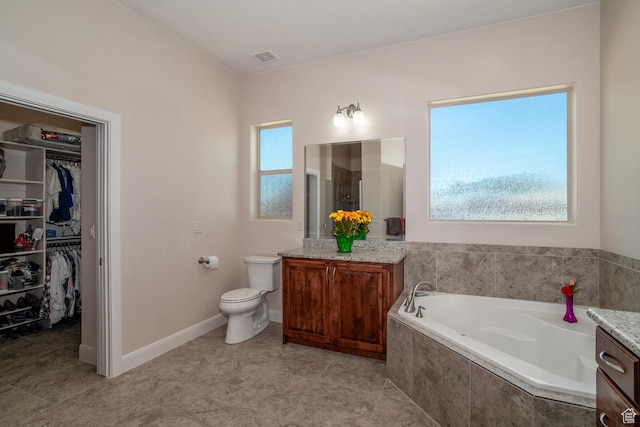814 N High Ground Dr, Dammeron Valley, UT 84783 - bathroom featuring vanity, a garden tub, toilet, and a walk in closet