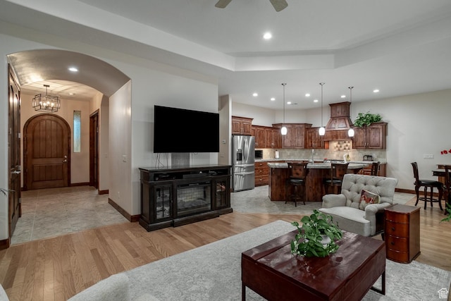 814 N High Ground Dr, Dammeron Valley, UT 84783 - living room featuring light wood-style flooring, arched walkways, recessed lighting, baseboards, and a raised ceiling