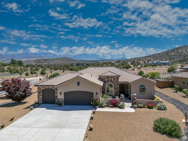 814 N High Ground Dr, Dammeron Valley, UT 84783 - mediterranean / spanish house featuring a garage, a mountain view, and stucco siding