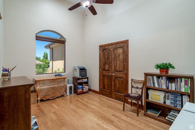 814 N High Ground Dr, Dammeron Valley, UT 84783 - sitting room featuring light wood-type flooring, a ceiling fan, and a towering ceiling