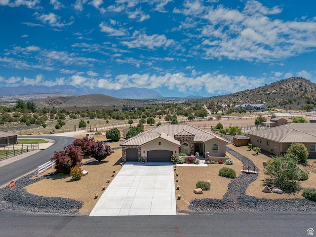 814 N High Ground Dr, Dammeron Valley, UT 84783 - view of front of property with an attached garage, a tiled roof, a mountain view, stucco siding, and driveway