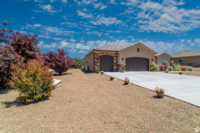 814 N High Ground Dr, Dammeron Valley, UT 84783 - mediterranean / spanish home with a garage, stone siding, concrete driveway, a tiled roof, and stucco siding