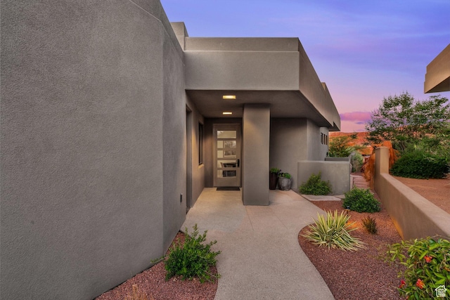 2549 W Sinagua Trl Unit 26, St George, UT 84770 - exterior entry at dusk with stucco siding