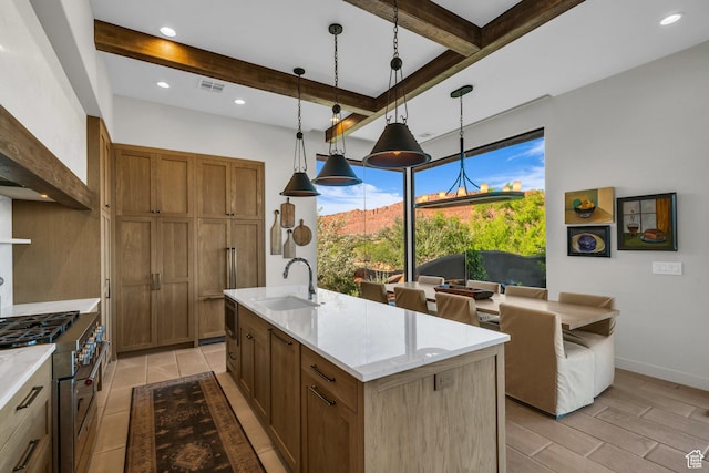 2549 W Sinagua Trl Unit 26, St George, UT 84770 - kitchen with a sink, high end stainless steel range oven, beam ceiling, brown cabinetry, and decorative light fixtures