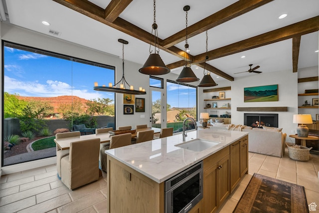 2549 W Sinagua Trl Unit 26, St George, UT 84770 - kitchen with a sink, open floor plan, stainless steel microwave, beam ceiling, and a ceiling fan