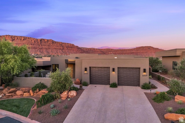 2549 W Sinagua Trl Unit 26, St George, UT 84770 - adobe home with a garage, driveway, a mountain view, and stucco siding