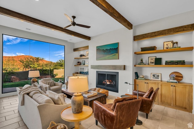 2549 W Sinagua Trl Unit 26, St George, UT 84770 - living room featuring a warm lit fireplace, beamed ceiling, a ceiling fan, and built in features