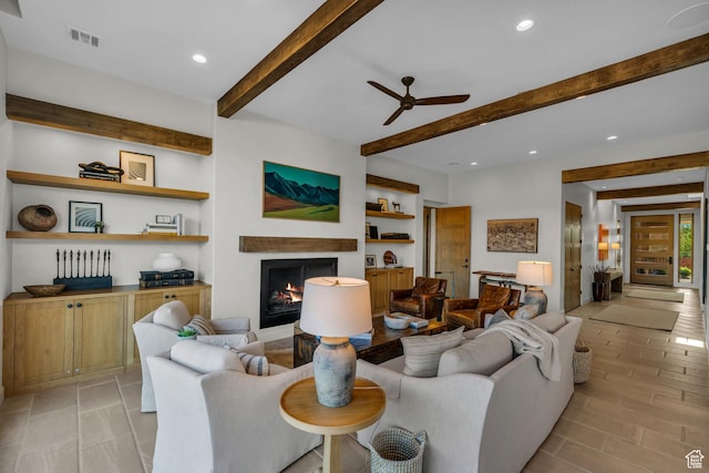 2549 W Sinagua Trl Unit 26, St George, UT 84770 - living area with beamed ceiling, a ceiling fan, recessed lighting, a warm lit fireplace, and built in shelves