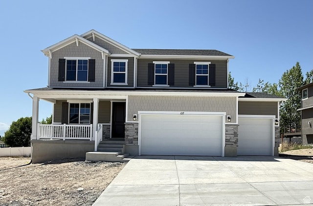 127 E Heron Ave Unit 808, Saratoga Springs, UT 84045 - view of front facade featuring covered porch, stone siding, driveway, and a garage