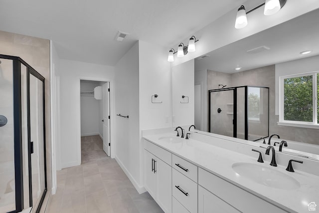 127 E Heron Ave Unit 808, Saratoga Springs, UT 84045 - bathroom featuring a shower stall, double vanity, a walk in closet, tile patterned floors, and baseboards