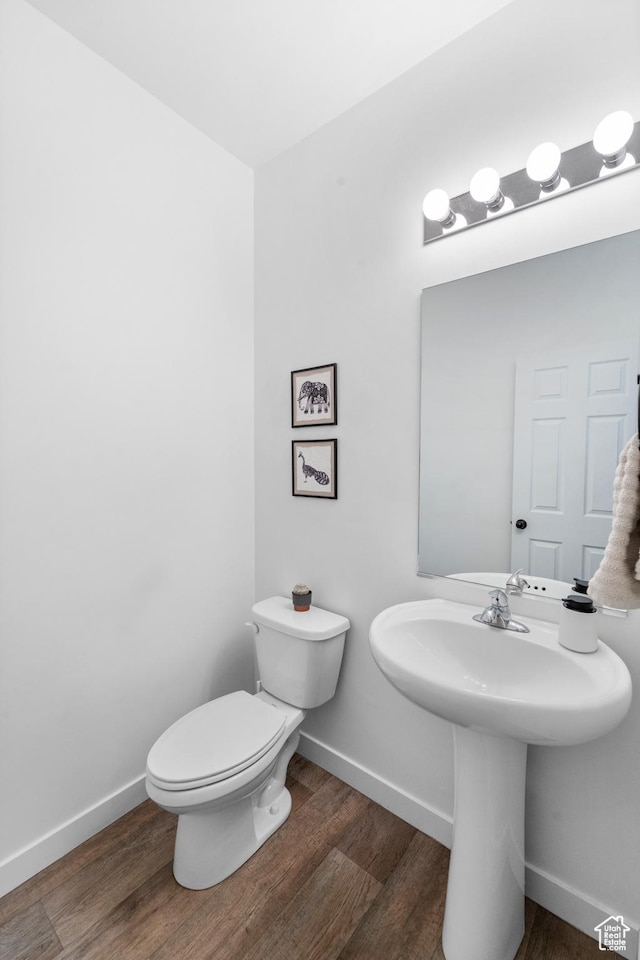 47 E Broxburn Way N, Tooele, UT 84074 - bathroom featuring wood finished floors, baseboards, toilet, and a sink
