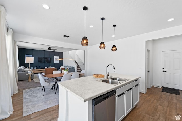 47 E Broxburn Way N, Tooele, UT 84074 - kitchen featuring stainless steel dishwasher, a sink, ceiling fan, wood finished floors, and recessed lighting