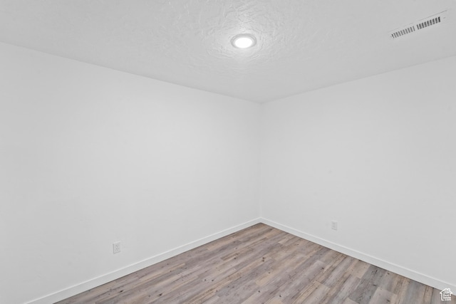 47 E Broxburn Way N, Tooele, UT 84074 - unfurnished room with baseboards, light wood-style flooring, and a textured ceiling