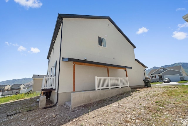 47 E Broxburn Way N, Tooele, UT 84074 - back of property featuring stucco siding and a mountain view