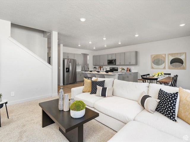 3453 S 3100 W Unit 0173, West Haven, UT 84401 - living room featuring recessed lighting, baseboards, stairway, light carpet, and a textured ceiling
