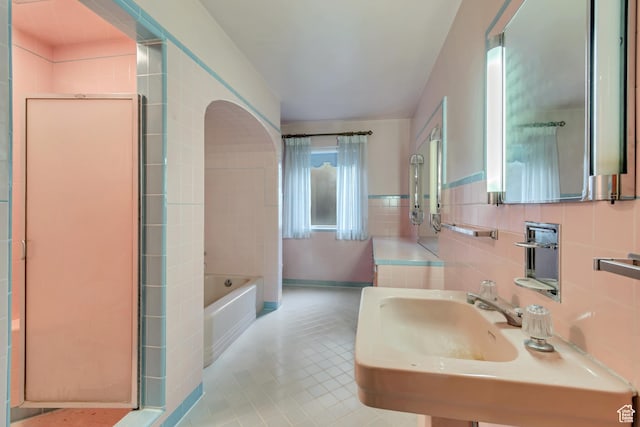 687 N Main St, Spanish Fork, UT 84660 - full bathroom with a garden tub, tile walls, tile patterned floors, and a sink